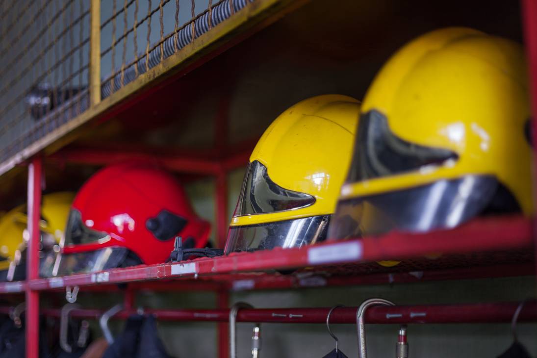 Closeup shot of a row of protective yellow helmets