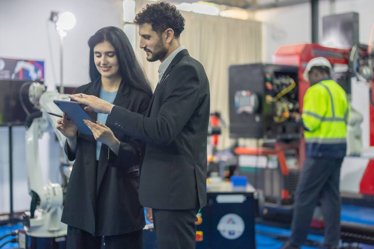 Robotic engineer and team oversee software, machine tool performance