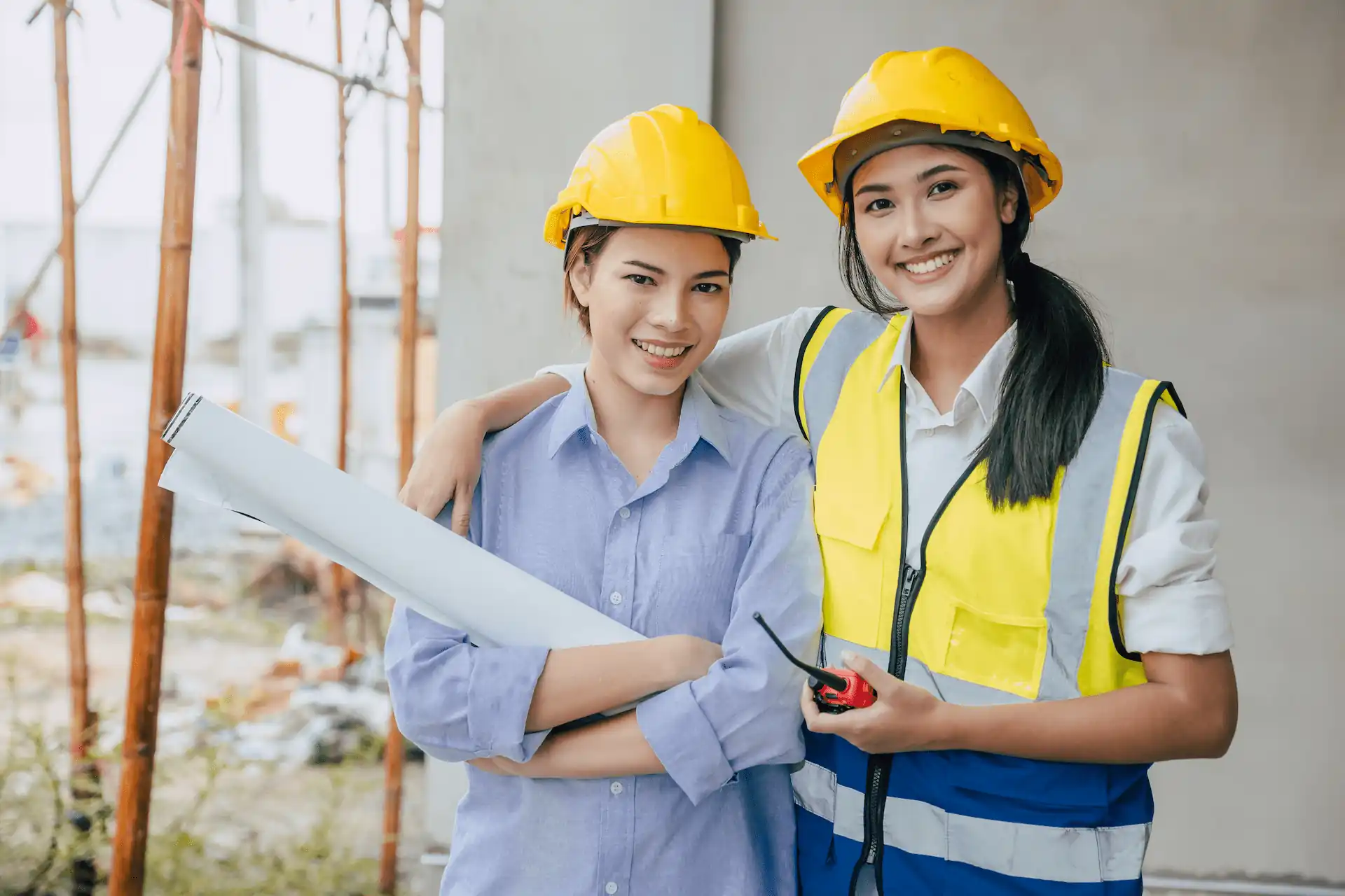 two women using PPE in construction site