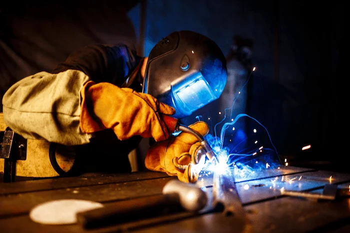 welder at work wearing welding helmet